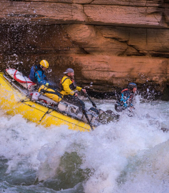 The crew rafting a river.
