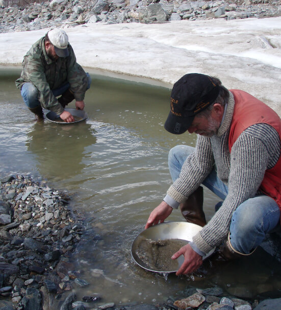 Two men gold panning in Alaska wilderness